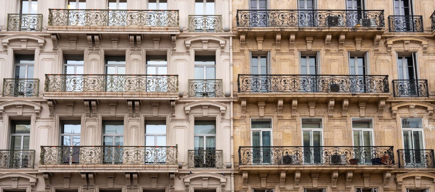 Elegant facade of a Toulon building with intricate wrought iron balconies.