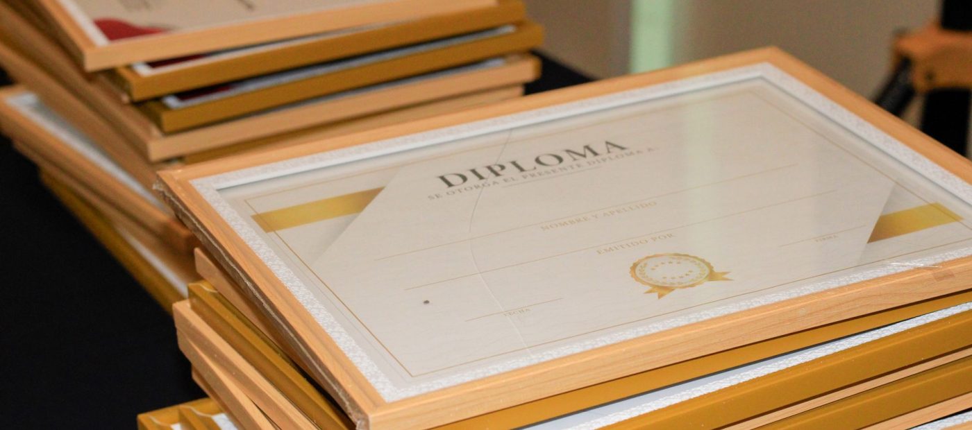A stack of elegant framed diplomas prepared for an academic ceremony.